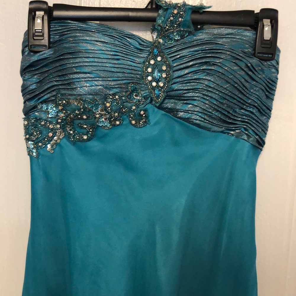 Teal, one shoulder gown.